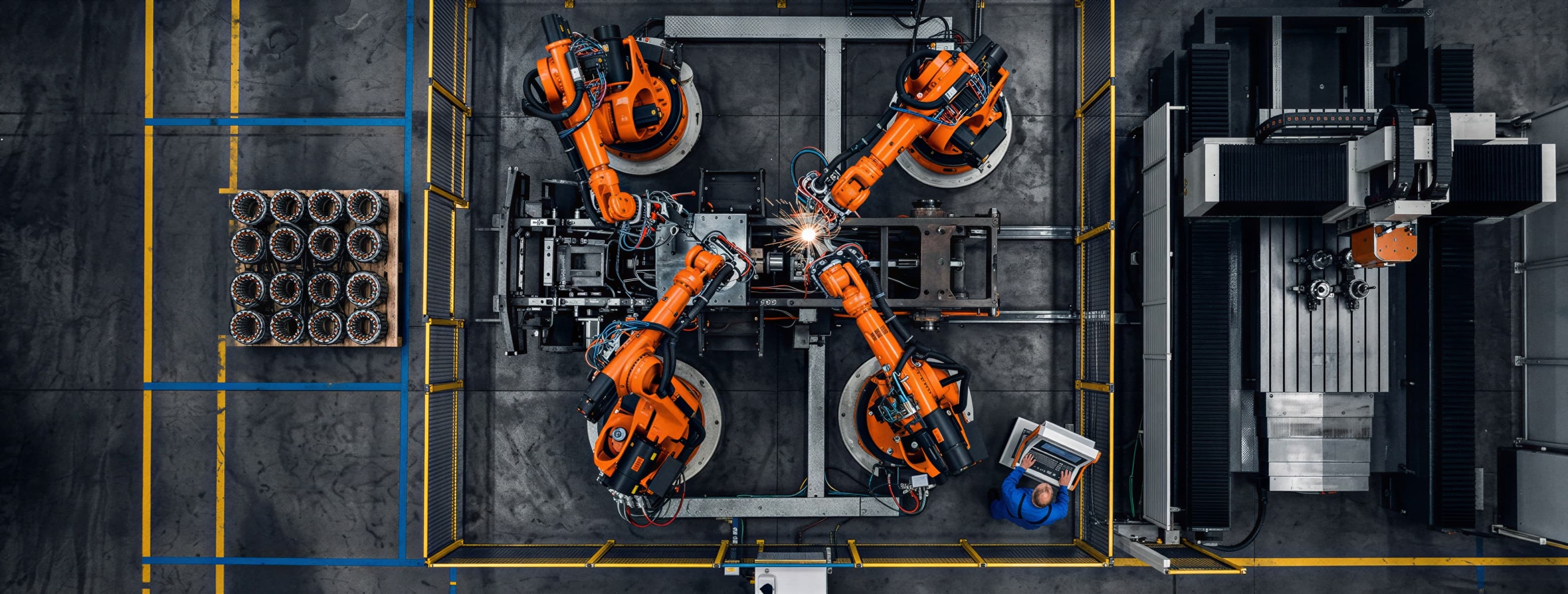 Aerial view of robotic arms in a manufacturing facility